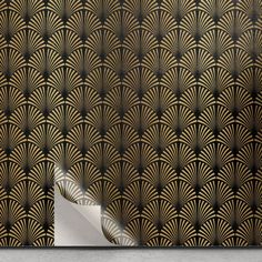 an abstract art deco wallpaper with gold and black fan pattern on it's side