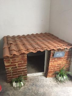 a dog house made out of bricks and clay