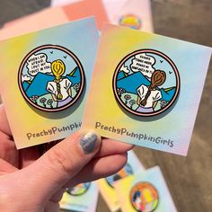 two stickers with the words peachpumpkingirls on them are held in front of each other