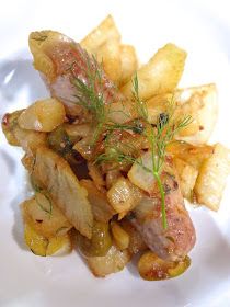 a white plate topped with meat and potatoes