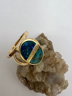 Designed and crafted by the owners and operators of the Miner's Emporium Jewelry Store Located in Rocky Mount, NC. This 14K, yellow gold ring is composed of genuine turquoise and black opal gemstones in an intarsia style. The ring is oval shaped with a solid back and there is a double shank. The gemstones were hand cut by owner and jeweler Scot Slep. This ring was entirely designed and handmade by Scot Slep. *Gift Ideas* This gorgeous ring is the perfect gift for any special occasion, or just be Wave Ring Silver, Mens Emerald Rings, Handmade Turquoise Earrings, Opal Bangle, Opal Promise Ring, Rocky Mount Nc, Fire Opal Earrings, Opal Diamond Ring, Unique Opal