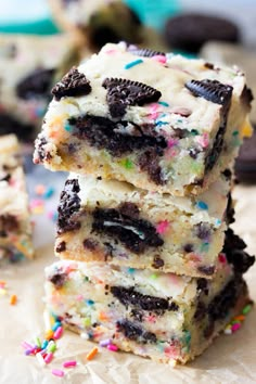 chocolate chip cookie bars stacked on top of each other with sprinkles around them