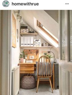 a chair sitting in front of a desk under a slanted roof