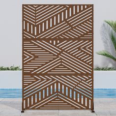 an outdoor wooden screen next to a swimming pool