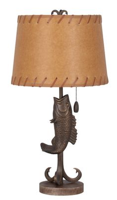 a lamp with a fish on it and a brown lampshade hanging from the side