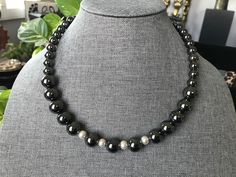 This choker necklace is substantial.  It is simple, classic and unique.   It has a matching bracelet. Both items are made with `12mm gunmetal hematite beads with pearl spacer beads.  It has a sweetheart lobster claw closure. The hematite stone is believed to dissolve negativity and prevents you from absorbing the negativity of others. Quality and durability are very important in handcrafting my designs.  I strive to make exceptional jewelry designs for all of my clients that will last for years. If you are not completely satisfied with your purchase, please let me know. Please visit my shop at etsy.com/shop/simplyunikcreations for other unique findings.   Thank you. Silver Magnetic Jewelry With Round Beads, Magnetic Silver Jewelry With Round Beads, Silver Hematite Necklace With 8mm Beads, Hematite Necklace, Necklace And Bracelet Set, Hematite Stone, Necklace And Bracelet, Matching Bracelet, Hematite Beads