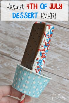 an ice cream popsicle with chocolate and sprinkles on it in a paper cup