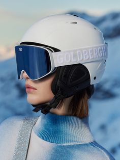 a woman wearing ski goggles and a white helmet