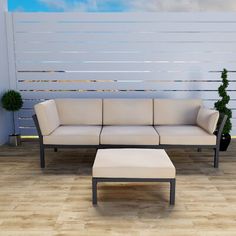 a white couch sitting on top of a hard wood floor next to a wooden table