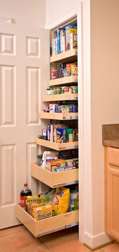 an organized pantry in the corner of a kitchen