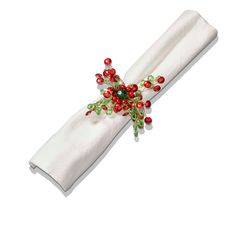 a white napkin with red and green decorations on the edge is folded in an ornament