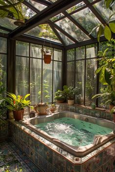 an indoor hot tub surrounded by potted plants and greenery in a greenhouse like setting