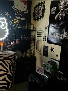 a bedroom decorated in black and white with pictures on the wall, zebra print bedding