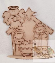 a wooden cutout of a nativity scene