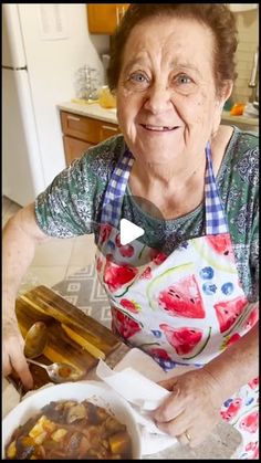 an older woman is holding a bowl of food in her hands and smiling at the camera