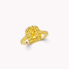 a yellow diamond ring on a white background