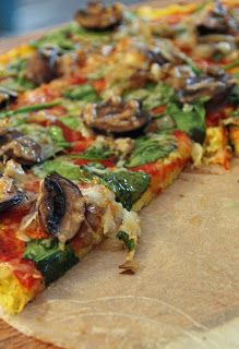 a vegetable pizza on a cutting board ready to be eaten