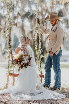 a bride and groom sitting on a swing