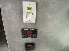 an electrical panel with two red and one green buttons