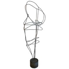 a wire sculpture is shown against a white background