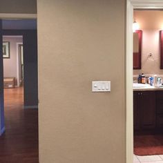 an open door leading into a kitchen with tile flooring