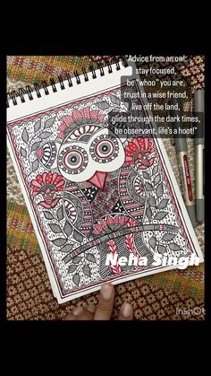 someone is drawing an owl on their notebook