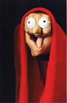 a person wearing a red scarf with googly eyes