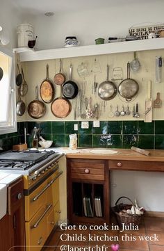 a kitchen with pots and pans hanging on the wall