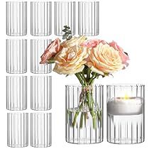 a vase filled with lots of flowers next to many empty glass tumblers on a white background