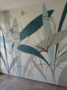 the wall is painted with flowers and leaves in blue, green, gray and white colors