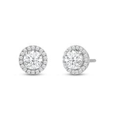 Classic round cut earrings with a stunning halo of round stones encircling the center stone.A lovely outfit-maker, this pair of stud earrings is what you need to give any ensemble a polished, put-together finish.