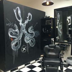 a black and white checkered floor in a barber shop with scissors drawn on the wall