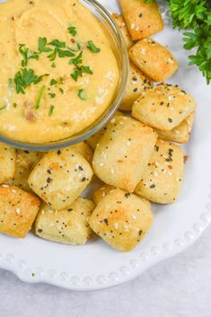 a white plate topped with tater tots covered in cheese