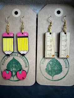 Show the teachers in your life how much you appreciate them with these darling back to school earrings. Each earring is meticulously handcrafted, made of wood, and hand painted. The earrings will make the perfect gift for that special teacher.  Due to the handmade nature of the earrings, they may vary slightly from those pictured.  Materials:  Maple wood Gold plated Stainless steel hypoallergenic hooks Drop length of ruler and pencil 2" from bottom of ear.  Can be purchased separately or as a bundle. Thank you for visiting my shop! Teacher Earrings Cricut, Clay Teacher Earrings, Teacher Beaded Earrings, Cute Teacher Earrings, School Earrings, School Staff And Teachers Appreciation, Teacher Earrings, Diy Teacher Gifts, Teacher Style