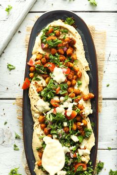 an overhead view of some taco shells with chickpeas and cilantro