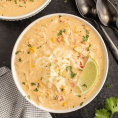 two bowls filled with soup and garnished with cilantro