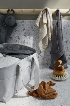 a large white bag sitting on top of a counter next to a brush and towel