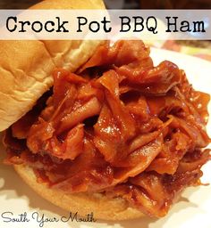 a close up of a sandwich on a plate with the words crock pot bbq ham