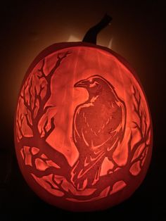 a carved pumpkin with a bird on it