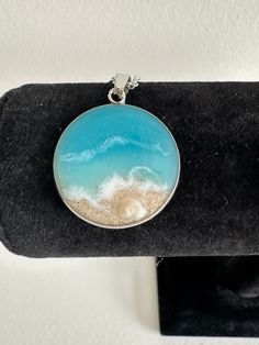 Resin beach necklace made with real sand comes in a beautiful velour pouch.  Material: Stainless steel silver chain and pendant Pendant: 25mm Chain: 20" lenght, width 2mm Sand: Punta Cana, Dominican Republic  Lead, nickel and cadmium free- hypoallergenic. Won't tarnish. Canadian orders will be shipped with REGULAR MAIL without tracking to save on shipping. Tracked shipping is available for an extra cost. I am not responsible for packages lost in the mail. USA orders will be shipped with tracking Strand Necklace With Lobster Clasp For Gift, Gift Necklace With Lobster Clasp And Strand Shape, Strand Necklace With Lobster Clasp As Gift, Ocean Color Beach Necklace, Ocean Color Round Necklaces For Beach, Turquoise Round Pendant Necklace For Beach, Silver Strand Necklace For Beach, Handmade Silver Necklaces For Vacation, Silver Necklace For Beach