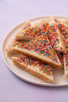 toasted sandwiches with sprinkles are on a white plate, ready to be eaten