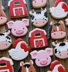 decorated cookies with farm animals and farm animals on them are displayed in front of a wooden table