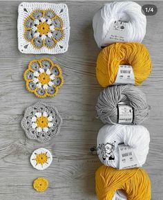 crochet grannys are arranged on a table with balls of yarn in them