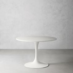 a white table sitting on top of a cement floor