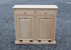 a wooden cabinet sitting on top of gravel