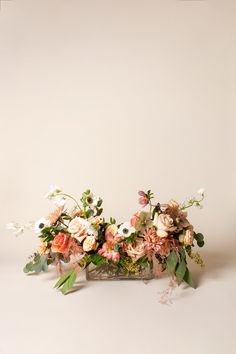 a vase filled with lots of flowers on top of a table