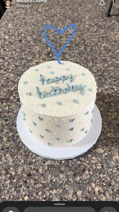 a birthday cake sitting on top of a counter next to a plate with the words happy birthday written on it