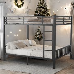 a bunk bed in a room with christmas decorations on the wall and lights around it