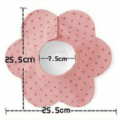 a pink flower shaped object with polka dots on it's side and measurements for the size