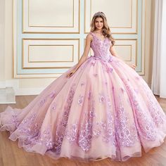 Celebrate in style in this extraordinary Quinceañera masterpiece. Crafted from sparkling glitter tulle and adorned with 3D floral embellishments, this showstopping ball gown ensures all eyes are on you. Featuring a stylish basque bodice adorned with sparkling sequins and shimmering beadwork, and a dramatic train edged in sleek horsehair, this one-of-a-kind gown sets the stage for a magical Quinceañera celebration. A matching capelet completes the showstopping style. Purple Quince Dress, Kids Pageant, Quincea�ñera Dresses, Crazy Dresses, Purple Things, Quince Dress, Prom Designs, Sweet 15, Fairytale Dress